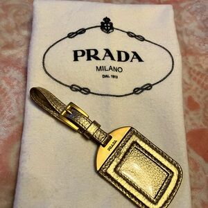 Authentic Prada luggage tag, gold leather & gold hardware some scratches. Gently
